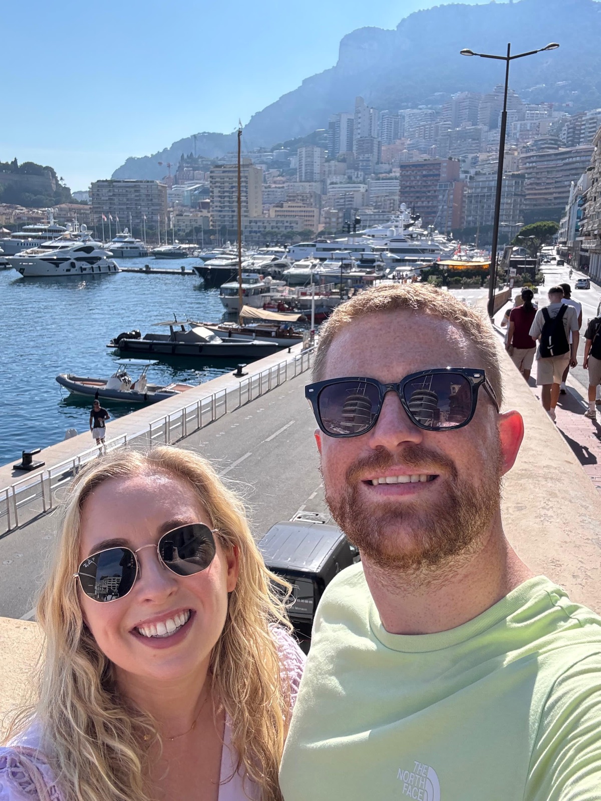 Zara and Alec on their travels, by a sunny harbour