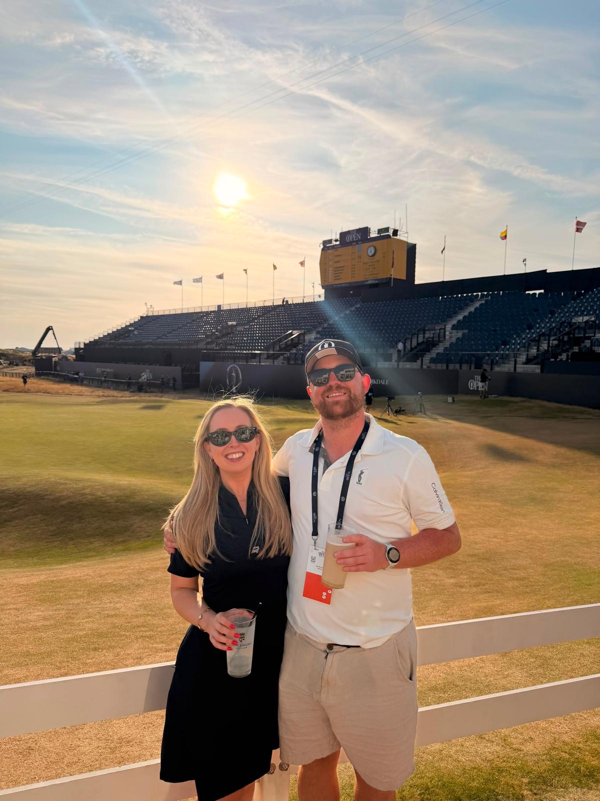 Zara and Alec at the golf, drinks in hand in the evening sun